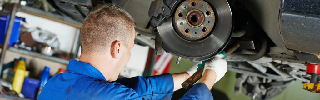 service technician inspecting brakes