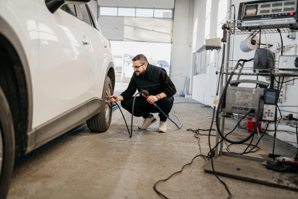 technician checking tire pressures 